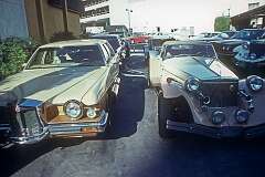 Car yard with modern retro-styled “classic” cars in Beverly Hills, California, USA, 1980; at right an Excalibur.
