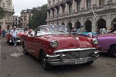 A 1956 Buick Roadmaster along Calle Obrapía, one of the vintage American cabriolets waiting for customers to take a tour of Havana, Cuba.