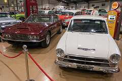 An Aston Martin DBS grand tourer (1967–1972) and a Lotus Cortina (Ford Cortina Lotus) of 1963.