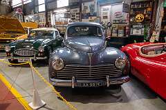 The French Peugeot 203, manufactured between 1948 and 1960; flanked by an Austin Healey 3000 Mk III and a Jaguar XK 120.