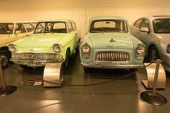 A 1959 Ford Anglia 105E, with its backward-slanted rear window, and a 1953 Ford Prefect 100E, remaining in production until 1959.