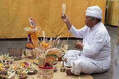 Ubud, Bali, Indonesia, 2019 - The priest performing a ritual in the Kuningan ceremony, in the Pura Taman Pule Mas family temple.
