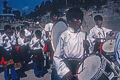 The drum band marching off.