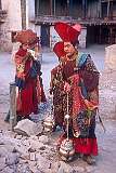 Monks with incense burners and a young monk blowing on a conch shell.