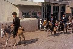 Men on donkeys at the entrance to the town of Aqqala or Ākgalā (then named Pahlavidezh).