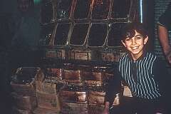 A boy in a shop selling dates, in the Grand bazaar of Tehran.
