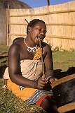 Motjane, Eswatini, 1970 - A Swazi woman, singing and drumming.