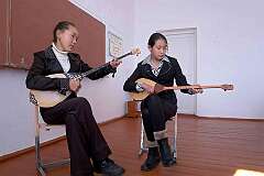 Katon-Karagay, Kazakhstan, 2011 - Playing the “dombyra”, a Kazakh long-necked lute, in the Lenin School.