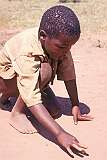 Lobamba, Eswatini, 1970 - A Swazi boy playing marbles.