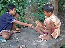 Suranadi, Lombok, Indonesia, 2005 - Boys playing a card game.